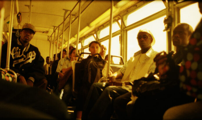 The inside of a bus shows eleven riders. No one is smiling.