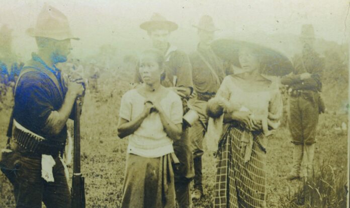 Military men confront Asian civilians.