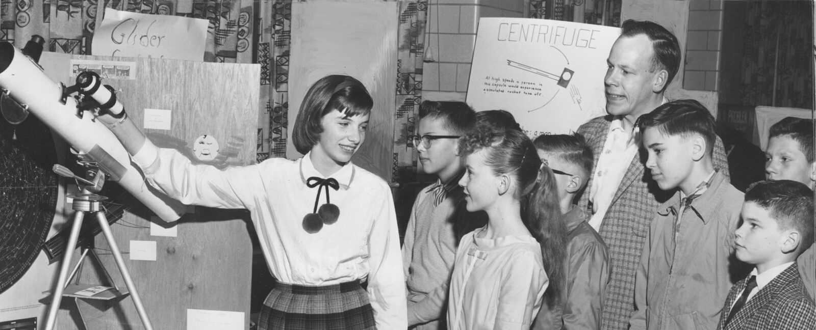 Thirteen-year-old Peggy Dibble shows her exhibit on "The Making and Use of a Telescope" at the 1961 King County Science Fair.