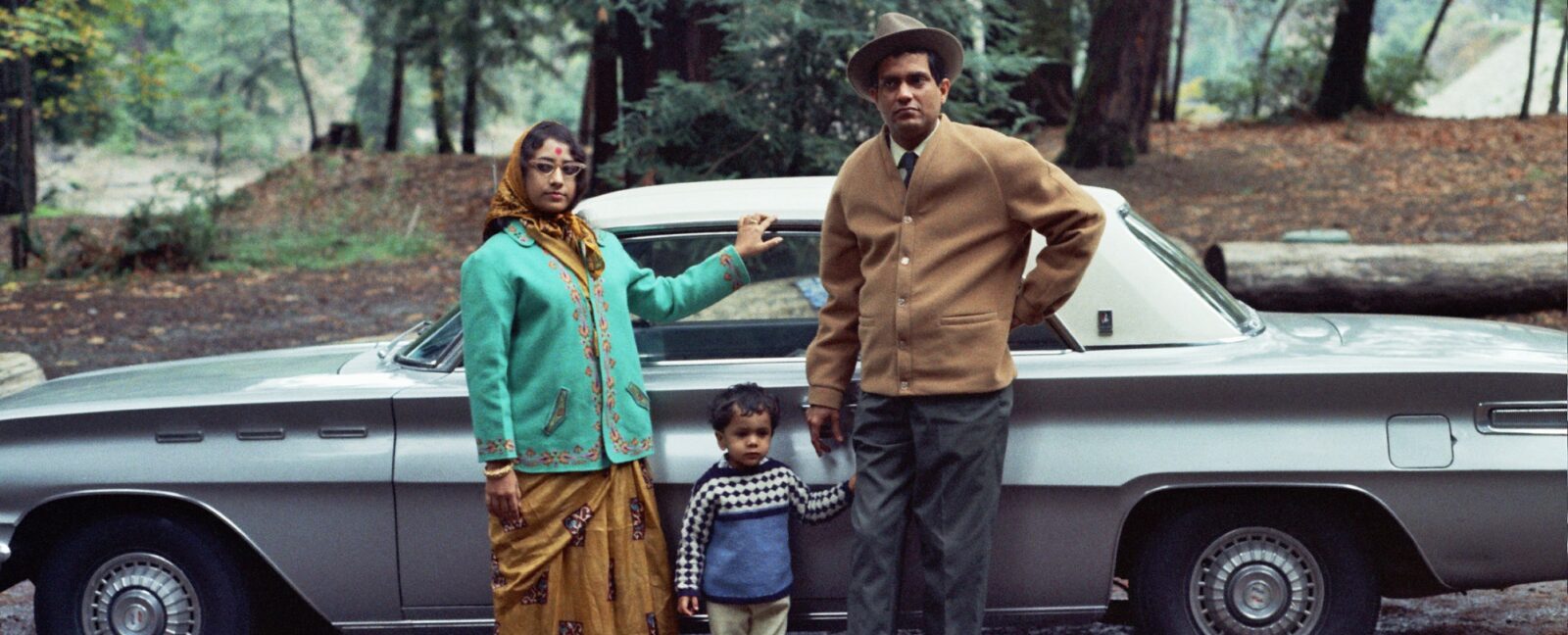 An Indian American family poses in front of their car in the 1960s.