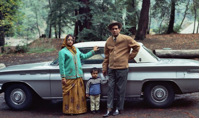 An Indian American family poses in front of their car in the 1960s.