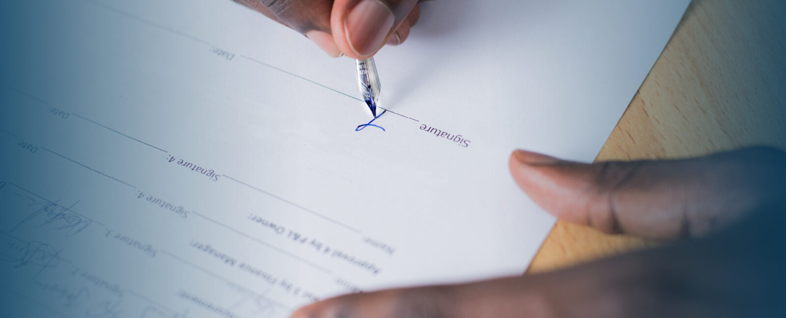 Person signing a document.