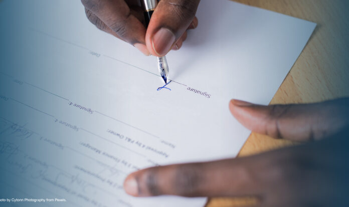 Person signing a document.