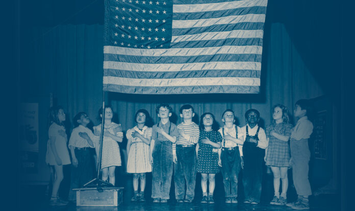 Children with left hands over hearts gazing at US flag.