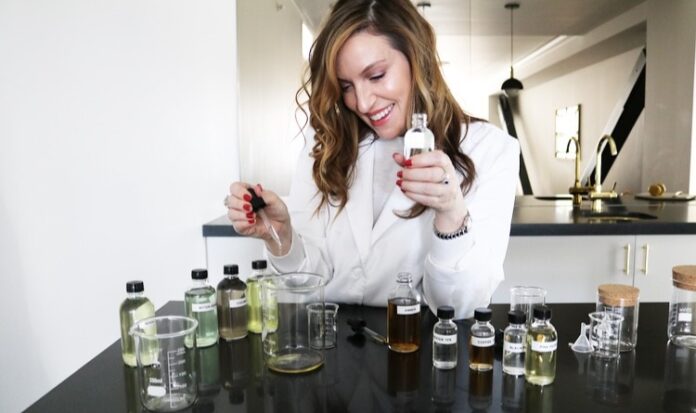 Molly Ray using a dropper to transfer liquid into a beaker.