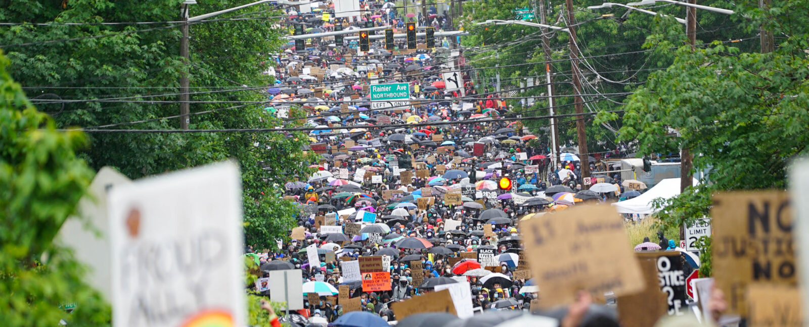 Crowd marching on Rainier Avenue Northbound in Seattle.