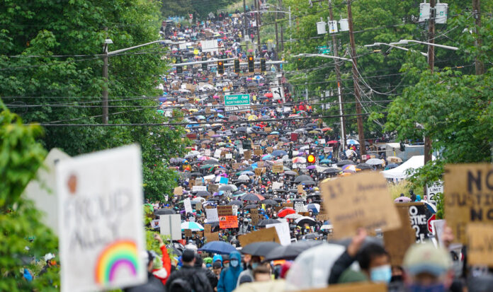 Crowd marching on Rainier Avenue Northbound in Seattle.