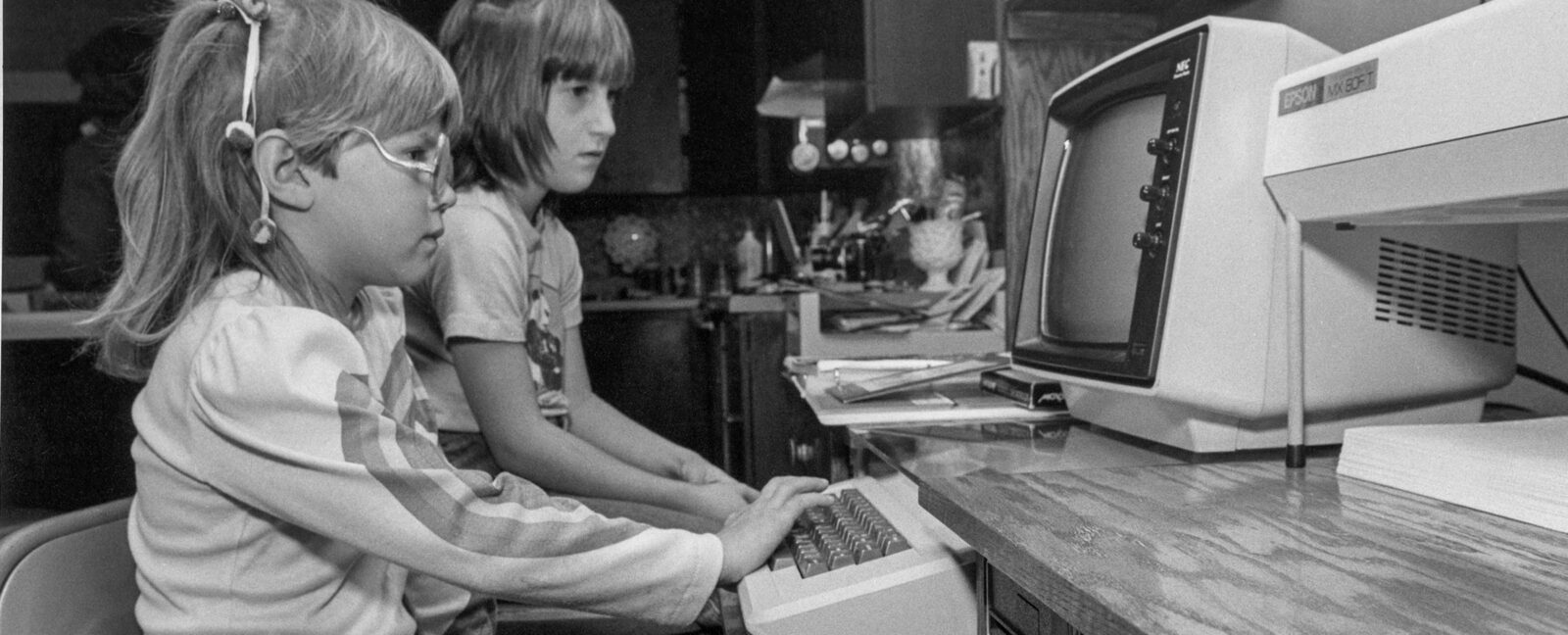 Two children using an Apple II computer.