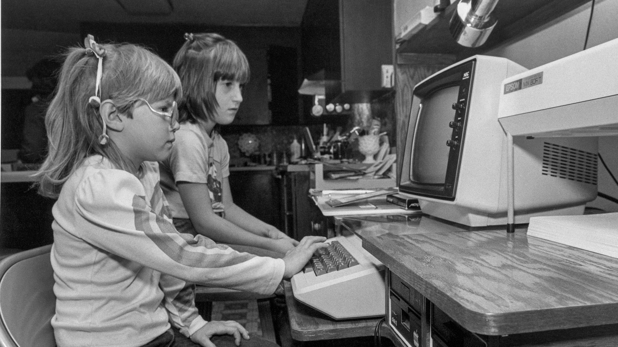 Two children using an Apple II computer.