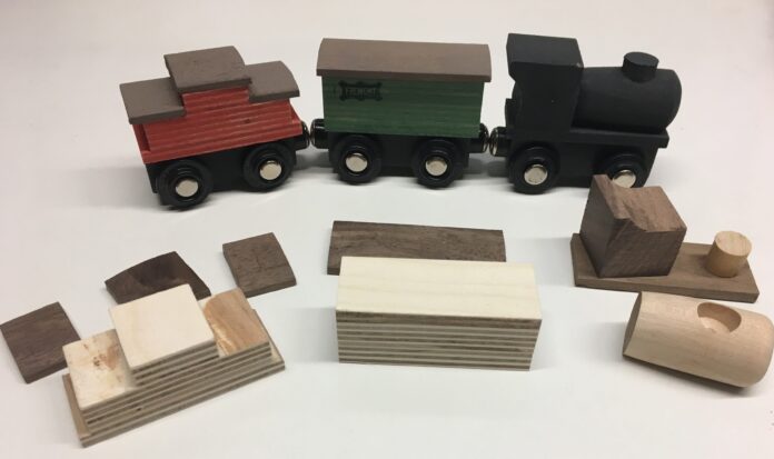 A collection of wooden trains and the components to build one.