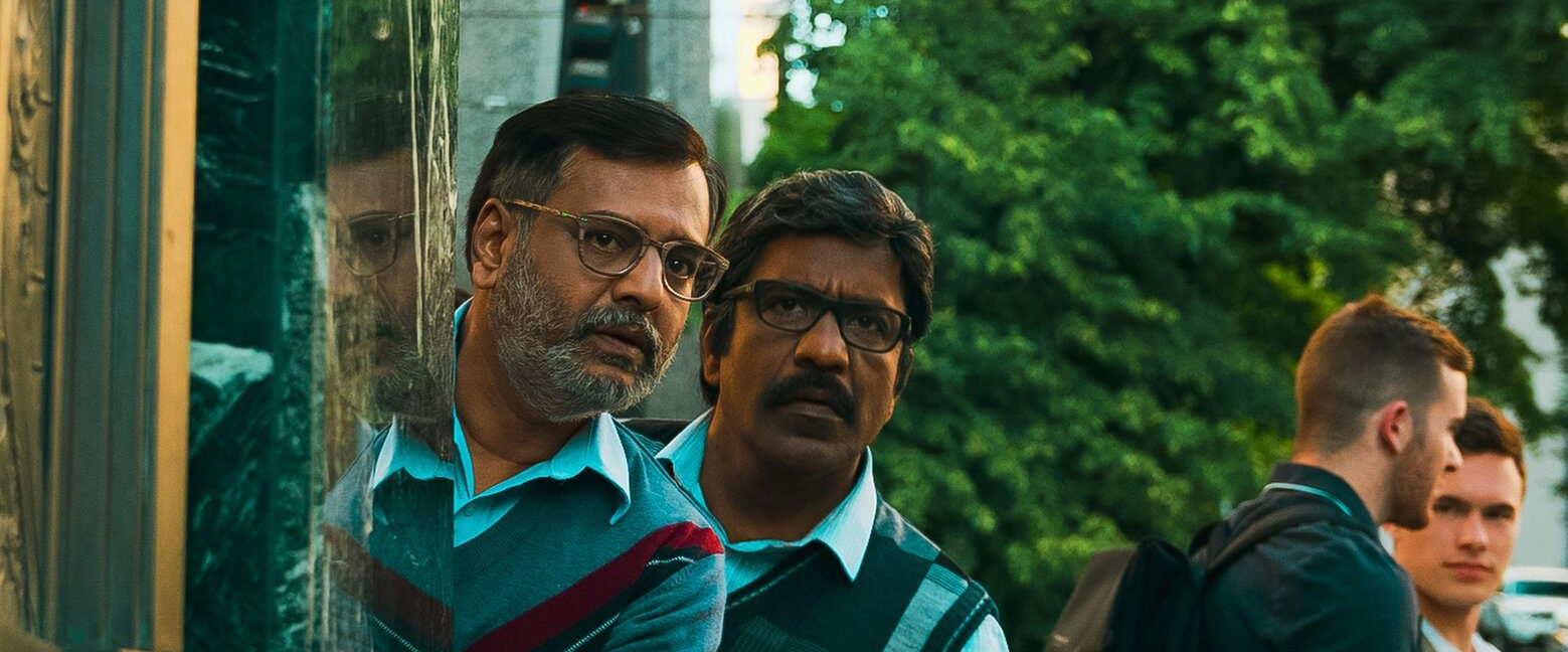 Vivek Elangovan and Vidhyashankar Balasubramaniyan peer around a corner.
