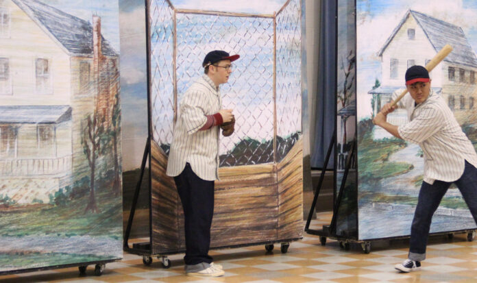 A performance at 5th Avenue Theater in Seattle shows two people playing baseball.