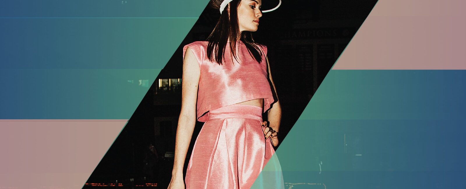 A woman in a pink dress and hat stands against a black background bordered by blue and pink.