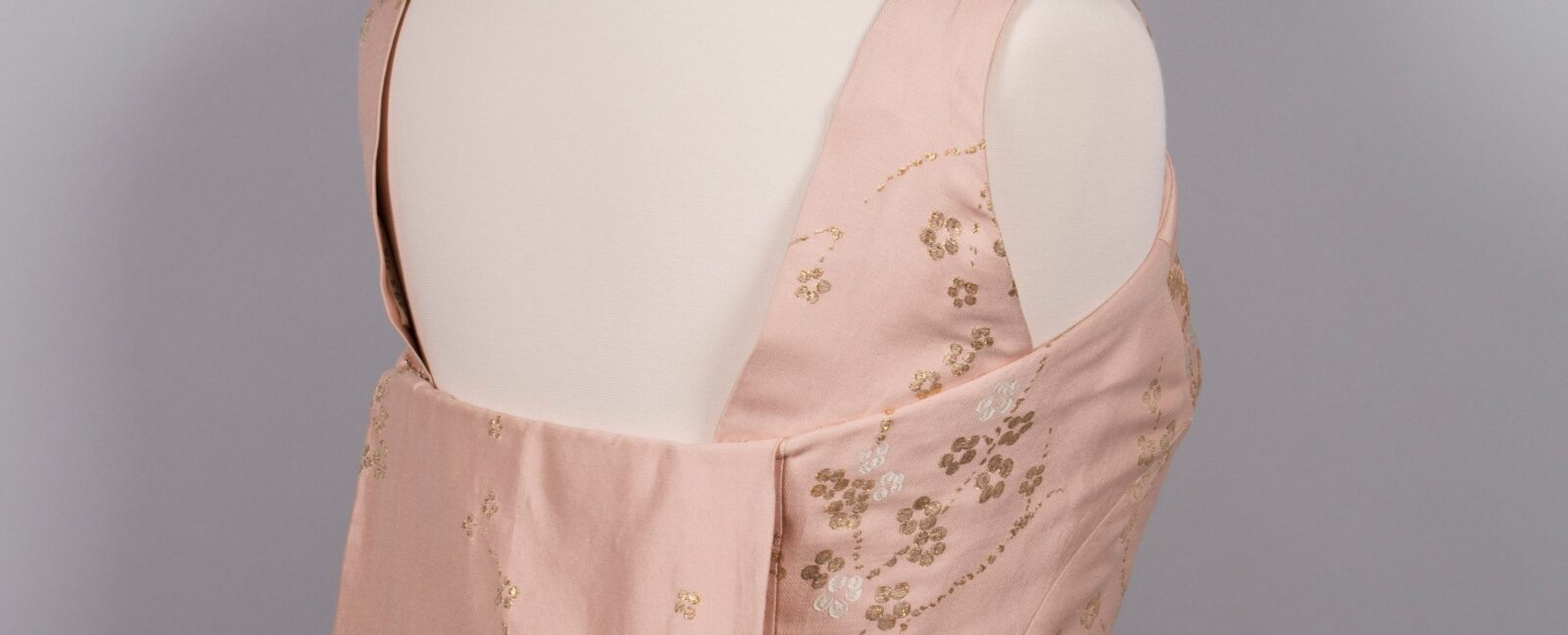 An open-back pink dress.