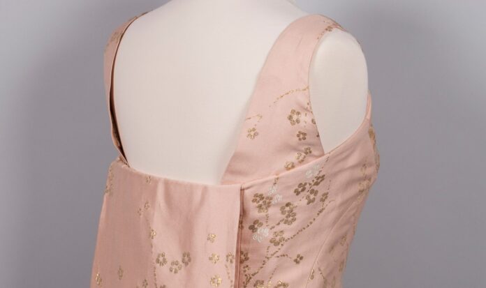 An open-back pink dress.