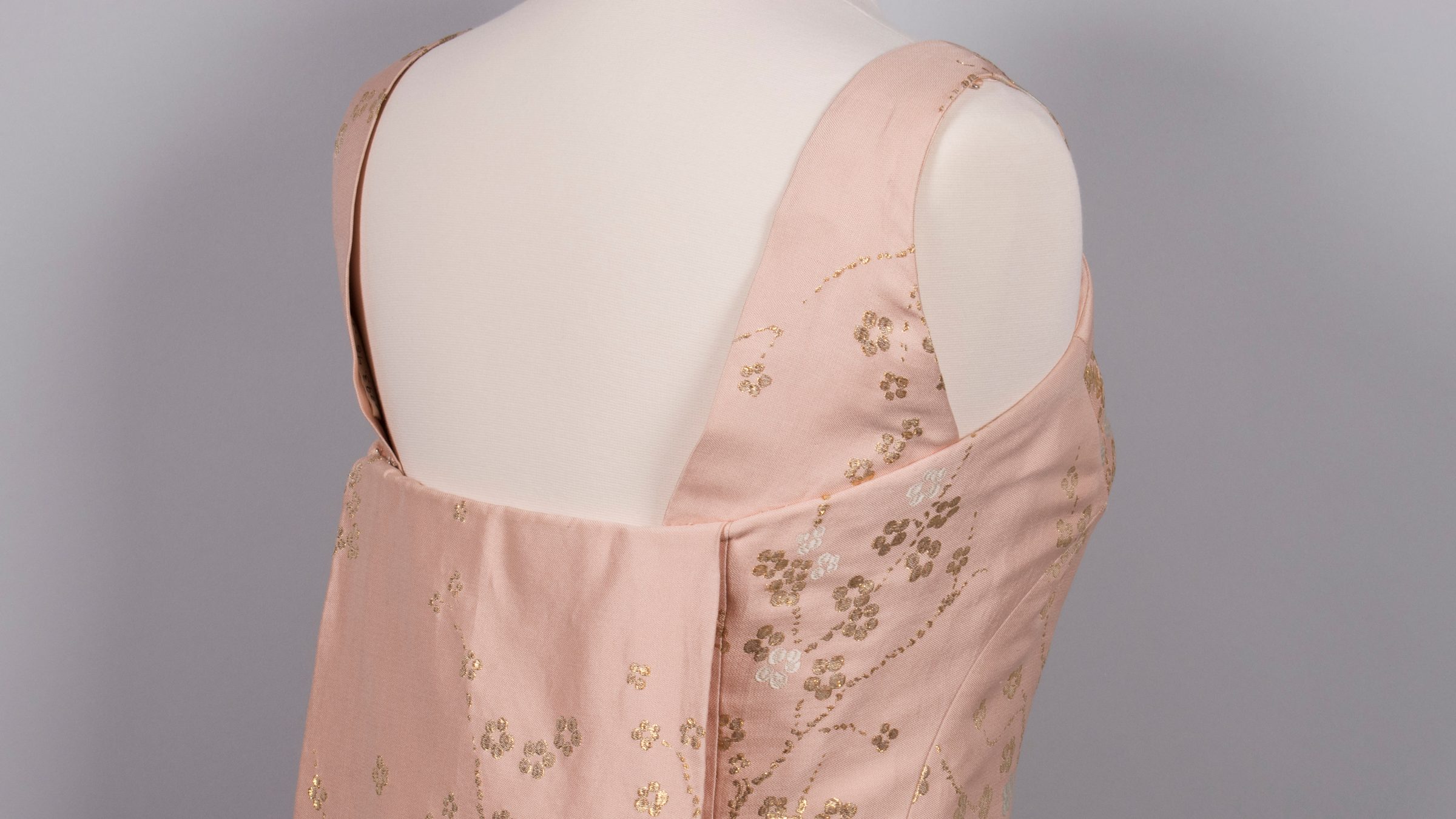 An open-back pink dress.