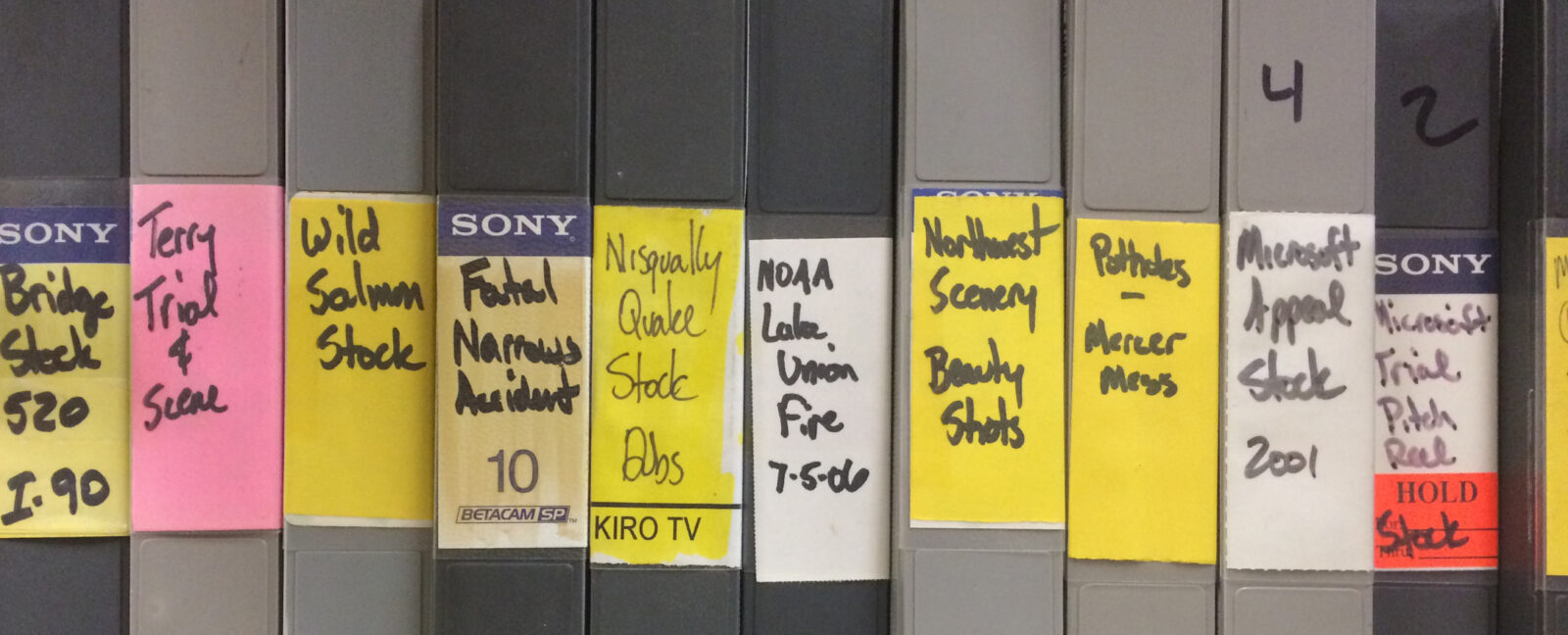 A row of grey binders on a shelf from the KIRO-TV archives.