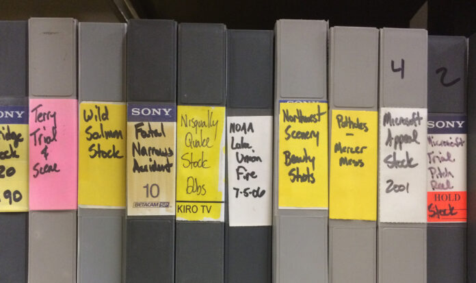 A row of grey binders on a shelf from the KIRO-TV archives.