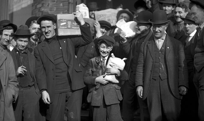 A group of men and a boy carrying groceries during the Seattle general strike