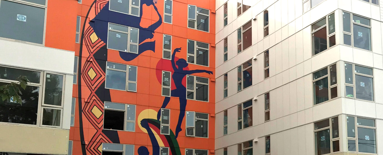 Exterior of the Liberty Bank Building painted orange with silhouettes of musicians and dancers.