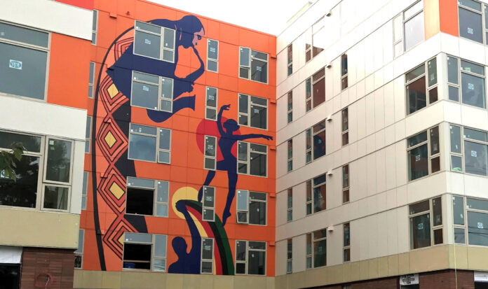 Exterior of the Liberty Bank Building painted orange with silhouettes of musicians and dancers.