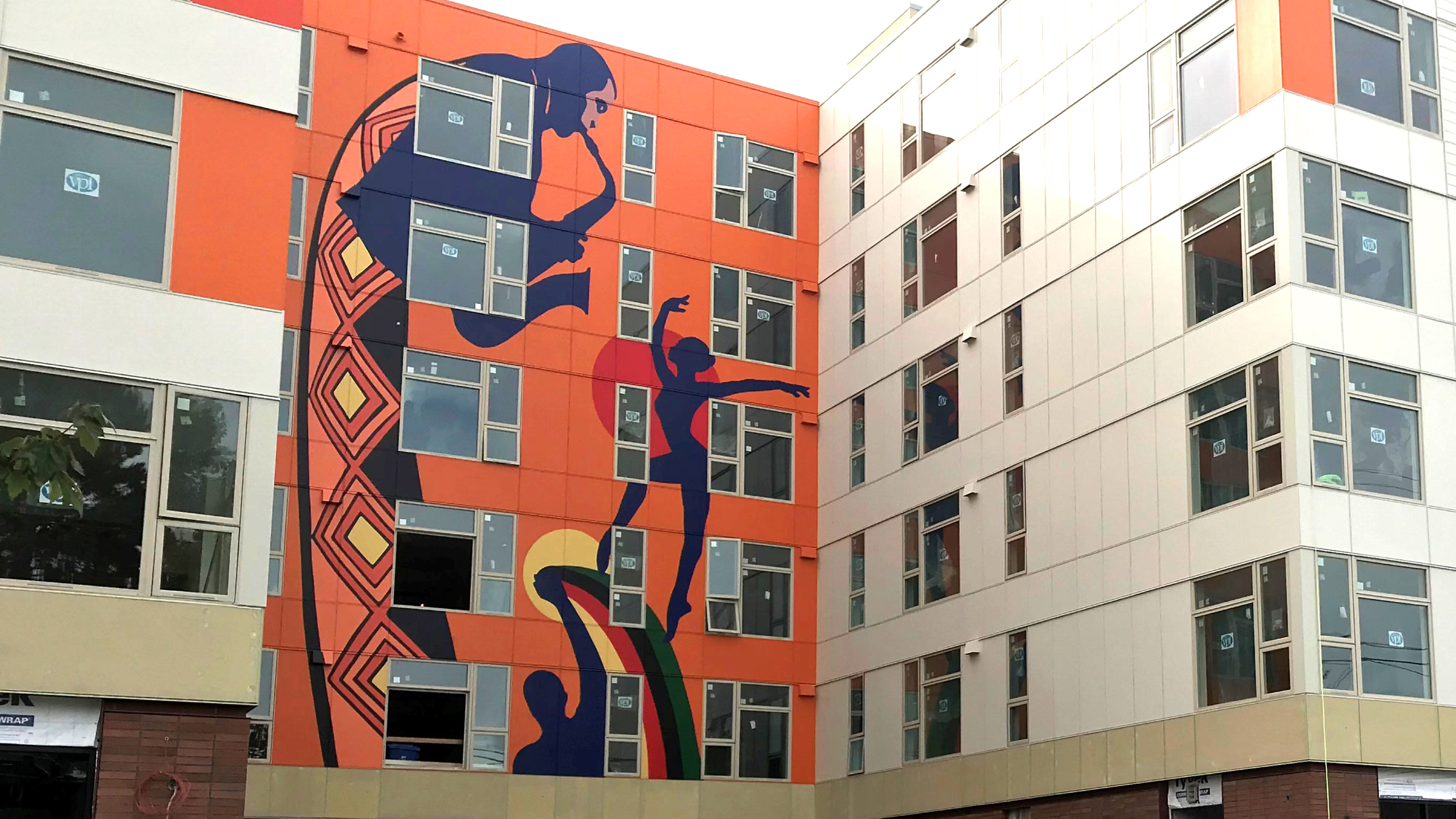 Exterior of the Liberty Bank Building painted orange with silhouettes of musicians and dancers.