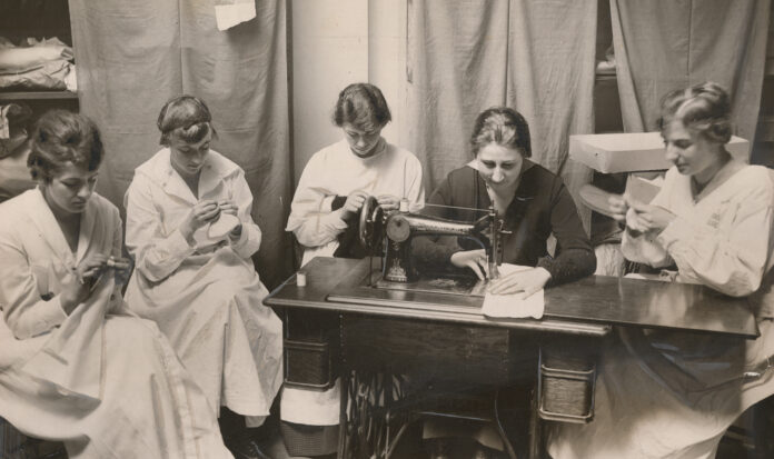 five Seattle members of the National Girl's Honor Guard sew layettes for babies