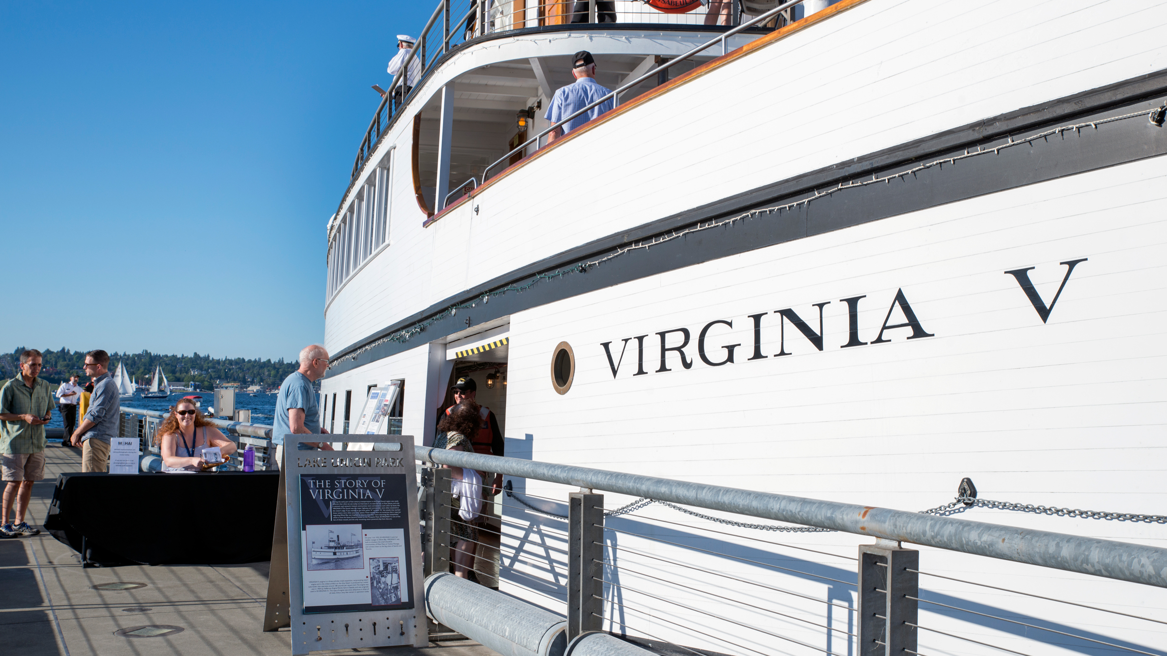 People bordering the SS Virginia V docked in Lake Union on a sunny day in Seattle