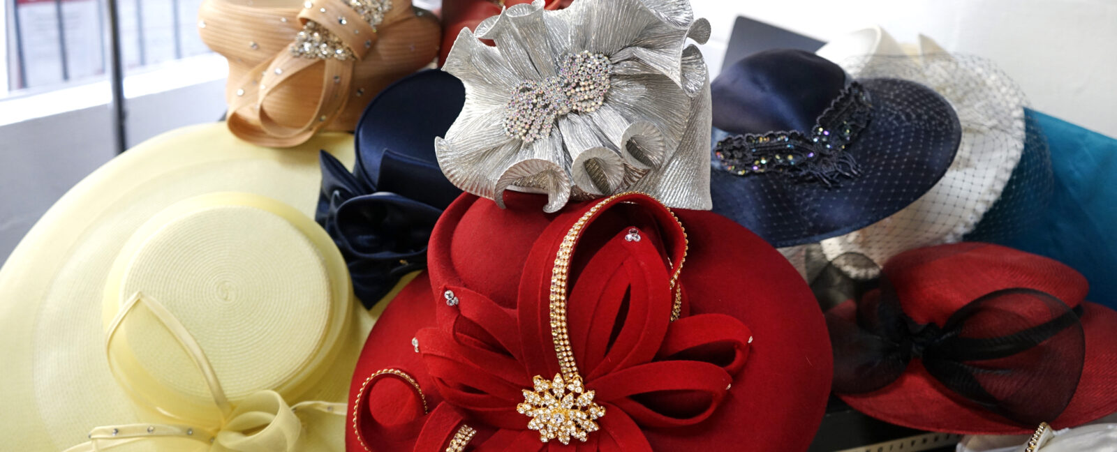 A pile of colorful hats (red