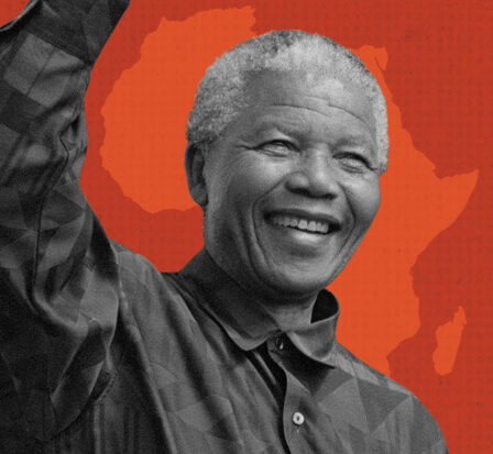 Nelson Mandela with right hand raise in the air standing adjacent to 