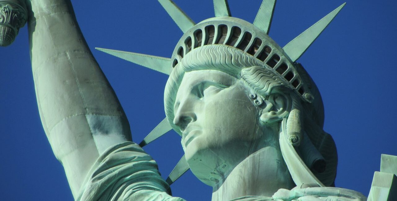 The Statue of Liberty against a clear, blue sky.