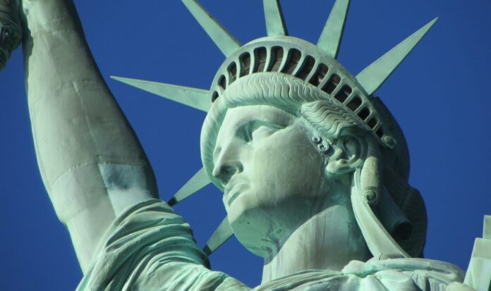 The Statue of Liberty against a clear, blue sky.