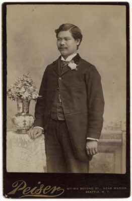 Mark Ten Suie, a Chinese American merchant who lived and worked in Seattle from 1876 through the 1920s show posing in suit circa 1885.