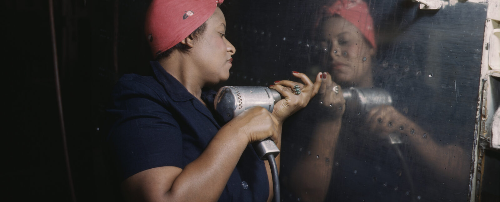 Operating a hand drill at Vultee-Nashville, woman is working on a "Vengeance" dive bomber, Tennessee, February 1943.