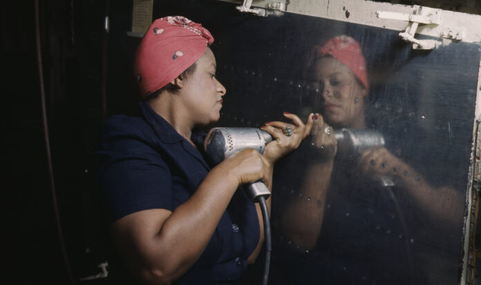 Operating a hand drill at Vultee-Nashville, woman is working on a "Vengeance" dive bomber, Tennessee, February 1943.