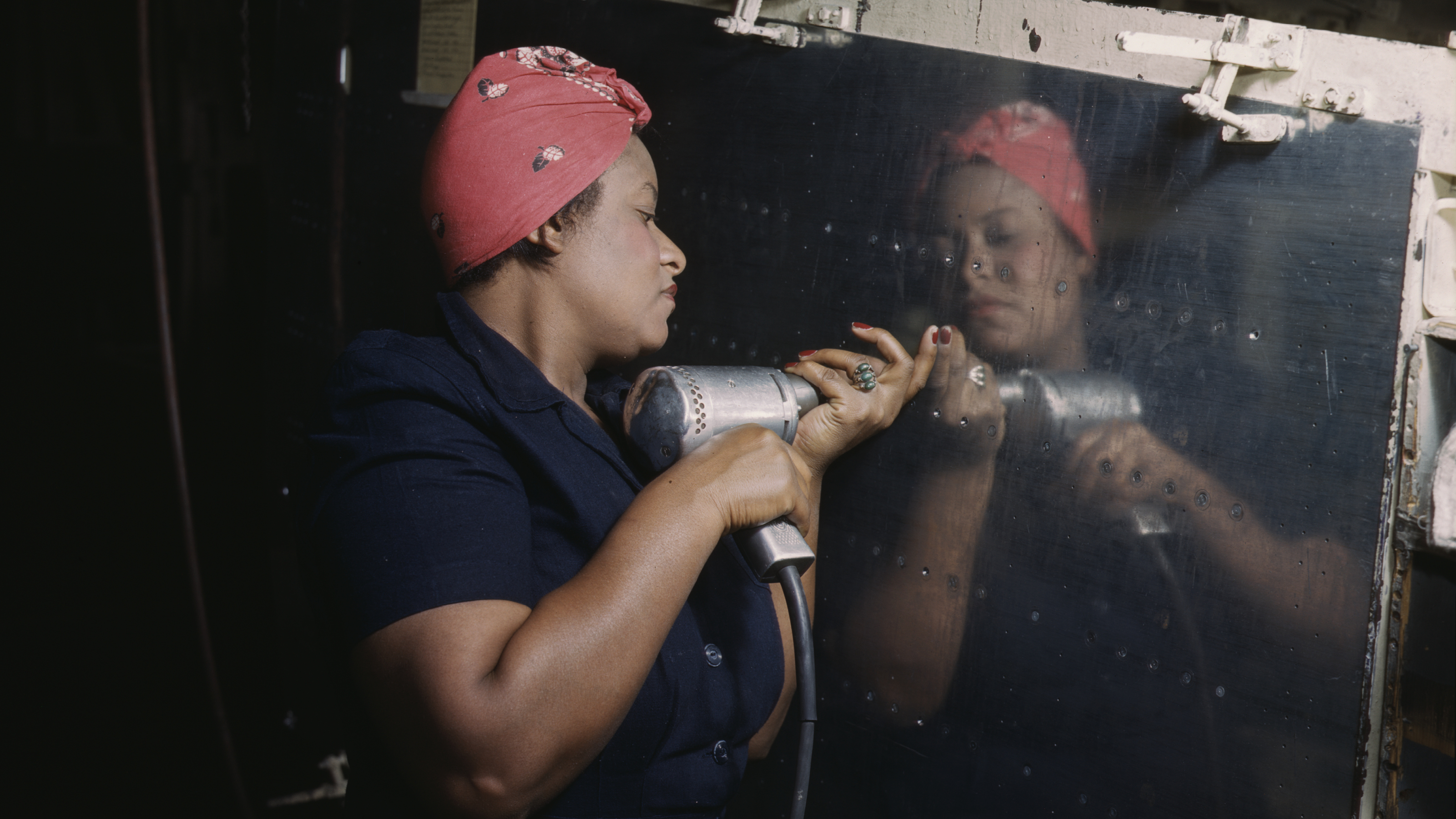 Operating a hand drill at Vultee-Nashville, woman is working on a "Vengeance" dive bomber, Tennessee, February 1943.