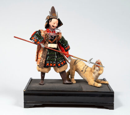 Photograph of a Japanese samurai doll with a tiger.