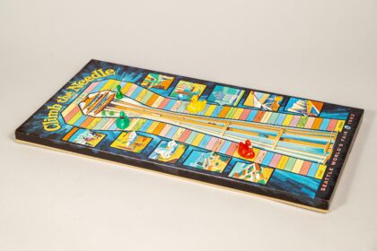 A retro board game shaped like the Space Needle, inspired by the 1962 World's Fair.