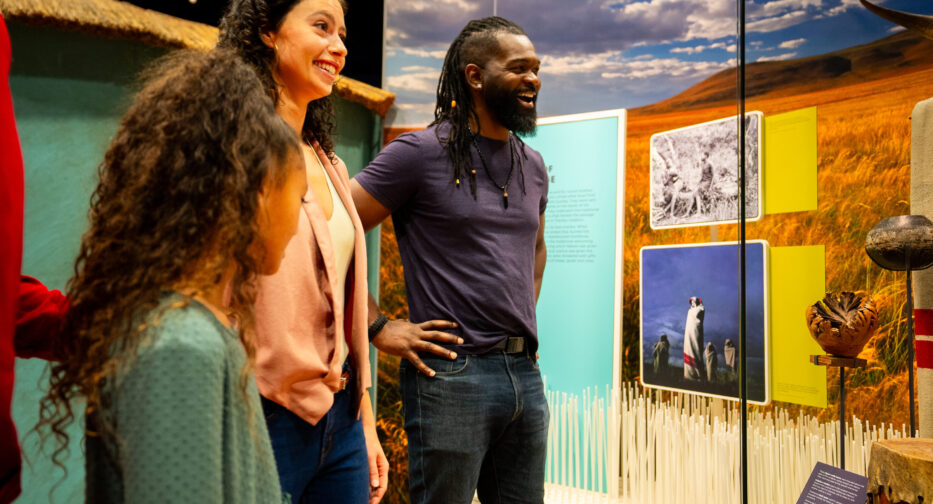 Visitors to the Mandela exhibit engaging with artifacts and photographs depicting the collective struggle of South Africans, highlighting the courage and unity that defined the anti-apartheid movement.