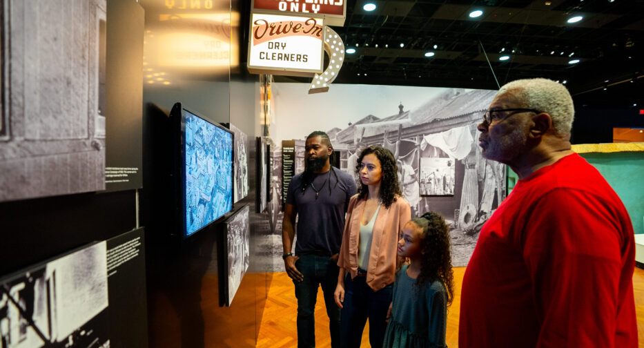 Visitors to the Mandela exhibit watching archival footage in The Struggle is My Life, seeing firsthand the powerful moments of resistance, resilience, and Mandela's unwavering fight for freedom.