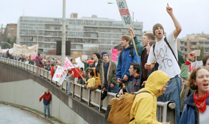 Individuals lined up at the WTO protests in Seattle, WA in 1999.