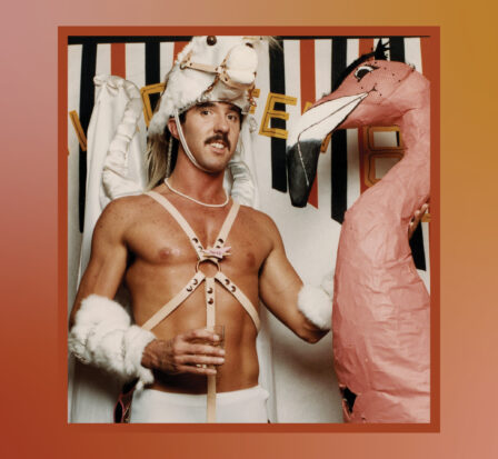Ric Weiland standing next to a pink flamingo.