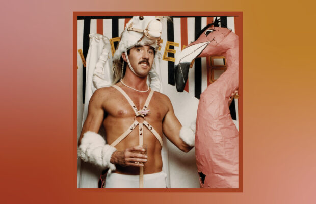 Ric Weiland standing next to a pink flamingo.