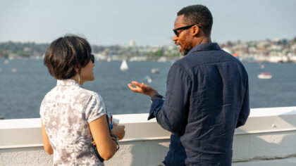 A couple talks while on the Lake Union Terrace at MOHAI.