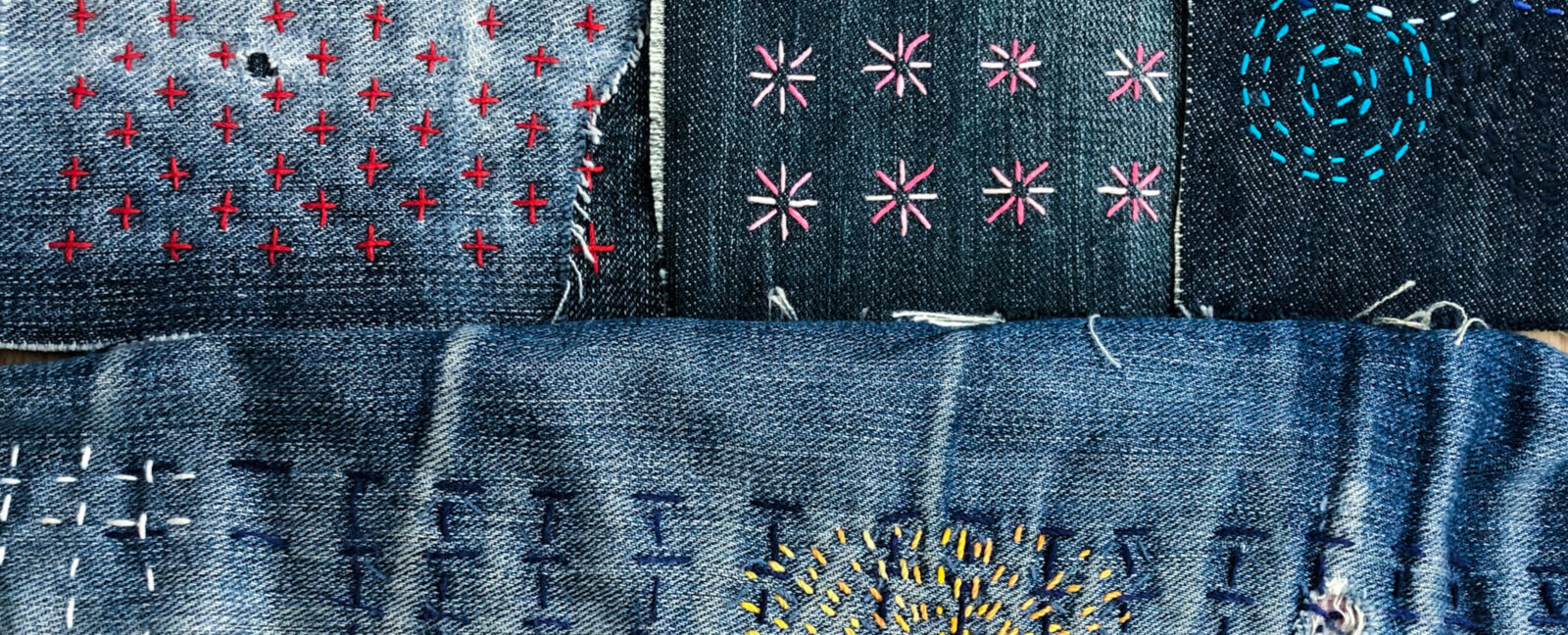 Various stitched patterns on denim fabric.