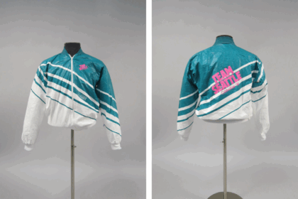 Vintage teal and white windbreaker jacket with diagonal stripes and "Team Seattle" and "GSBA" text on the chest.