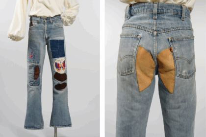 Medium wash bell-bottom jeans with embroidery patchwork on the legs and rear.