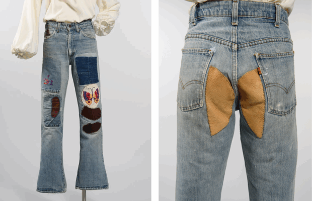 Medium wash bell-bottom jeans with embroidery patchwork on the legs and rear.