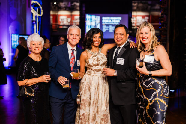 A group of five attendees pose for a photo during the 2024 MOHAI Gala.