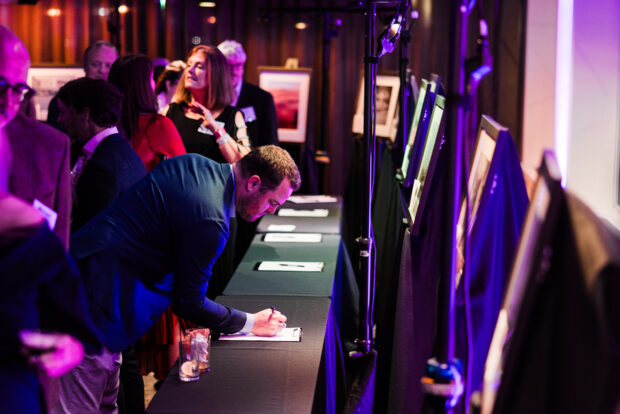 An attendee bids on a silent auction item during the 2024 MOHAI Gala.